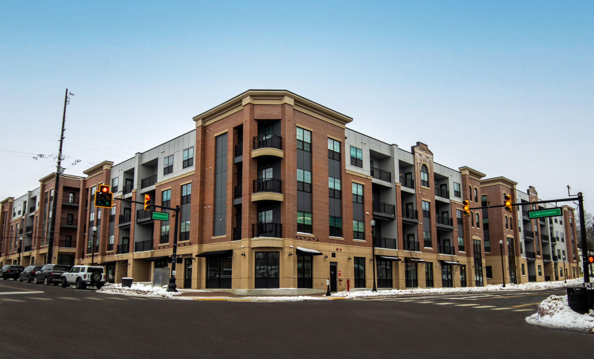 Street view of a large, modern apartment building