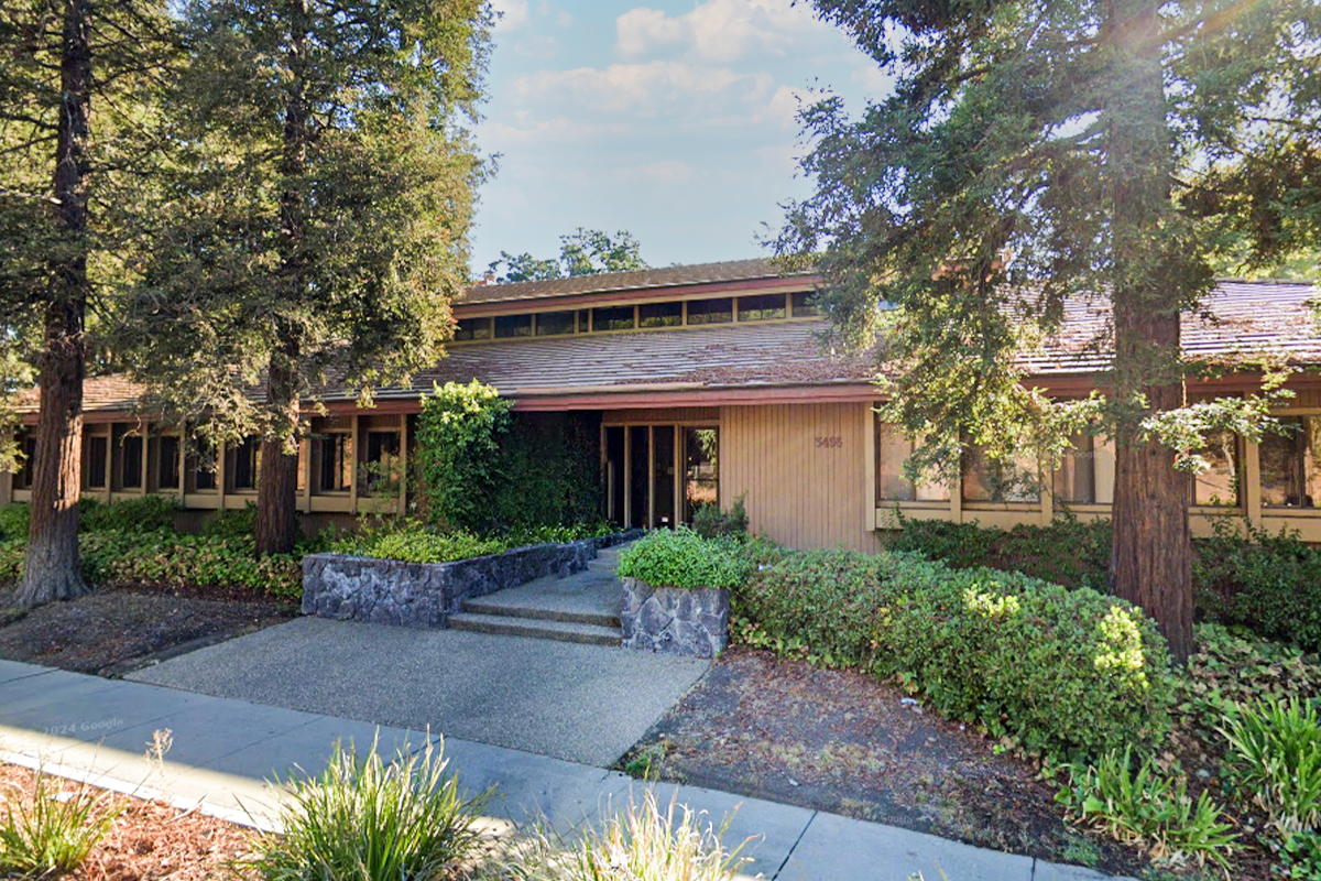 Exterior view of a an office building with trees in front of it
