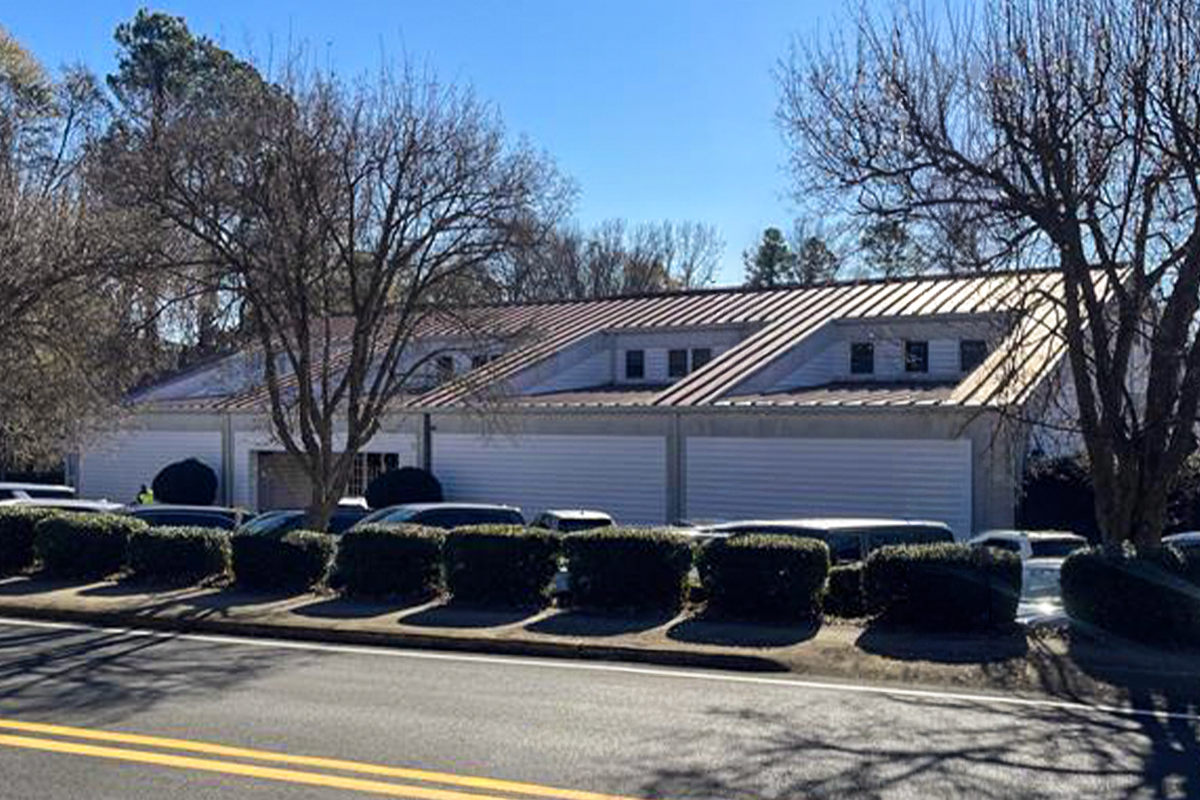 Exterior view of an office building with a street in front of it.